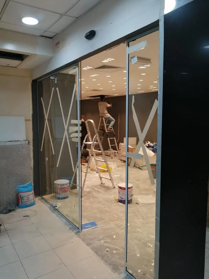 Glass retail storefront installation in progress